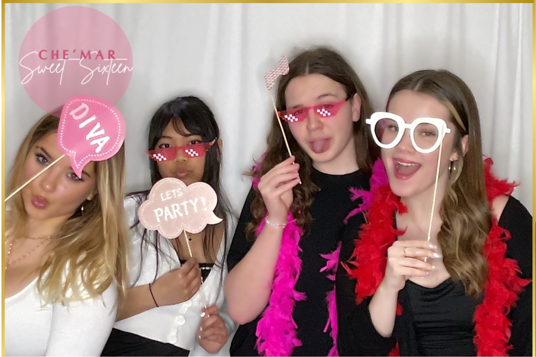 Friends having fun with colorful photo booth props
